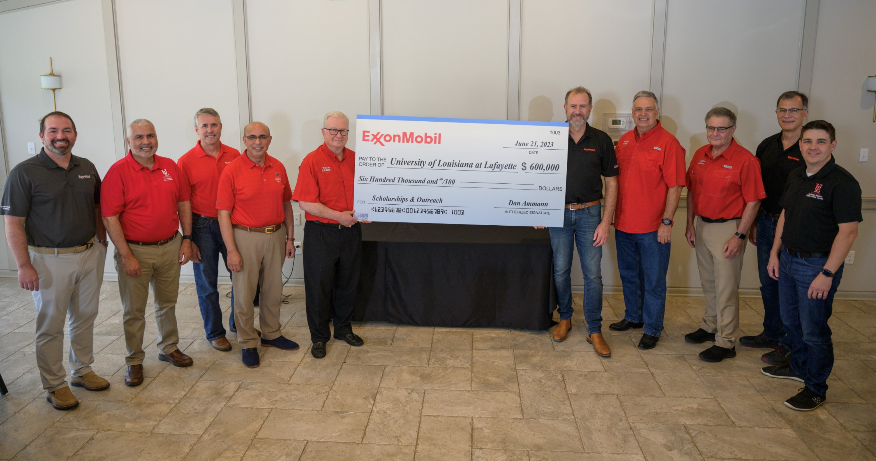 Image Dan Ammann, president of ExxonMobil Low Carbon Solutions (sixth from the left), presents a $600,000 check to the University of Louisiana at Lafayette President Dr. Joseph Savoie. The money will fund STEM scholarships for Vermilion Parish high school students and the universitys outreach on key energy topics.