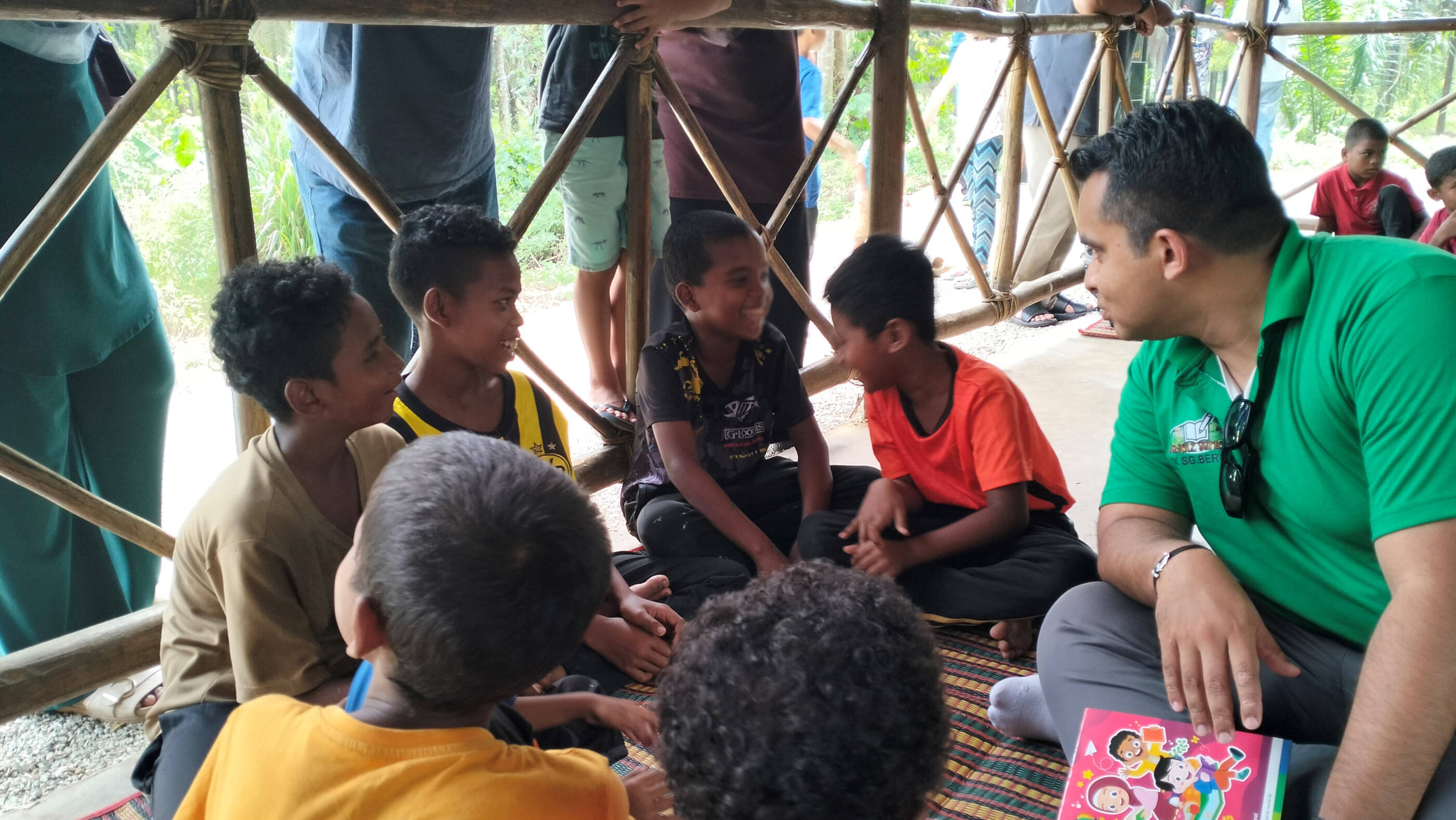 Hazizi engaging with local children at the Jungle School