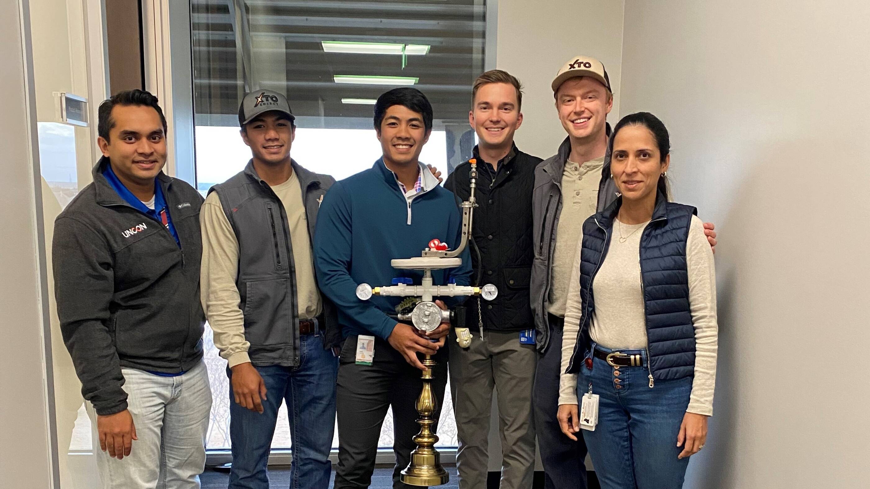 Hazizi with the facilities engineering team in the Midland Basin who drove a closed-loop gas capture project to reduce routine flaring